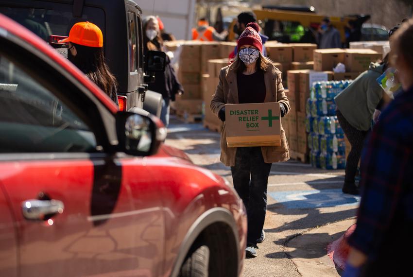 Volunteers distribute boxes of food at a distribution site in Austin on Feb. 19, 2021.